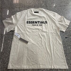 Fear of God ESSENTIALS Short Sleeve Tee in Light Cream with Black Logo
